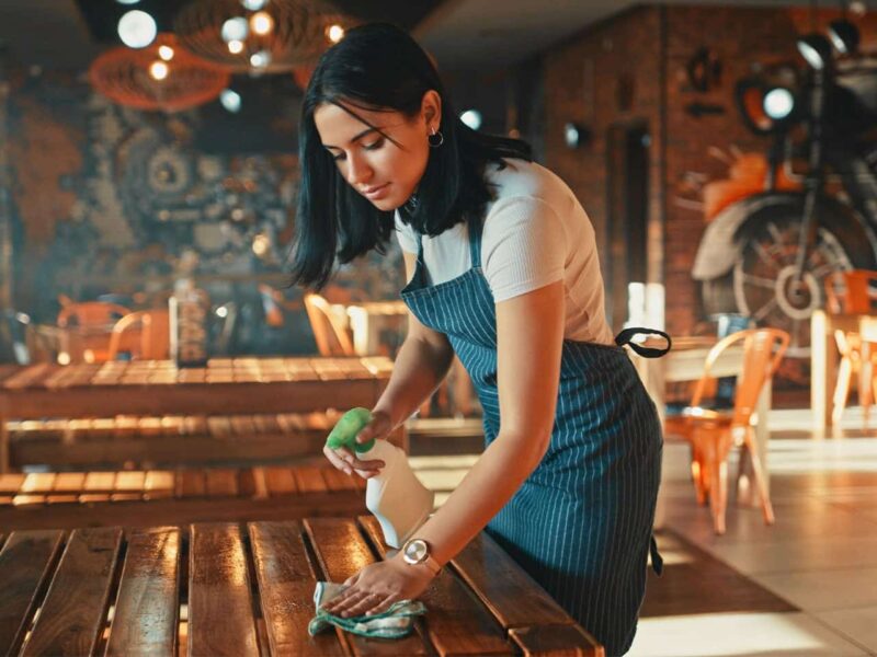 worker cleaning a table in a restaurant