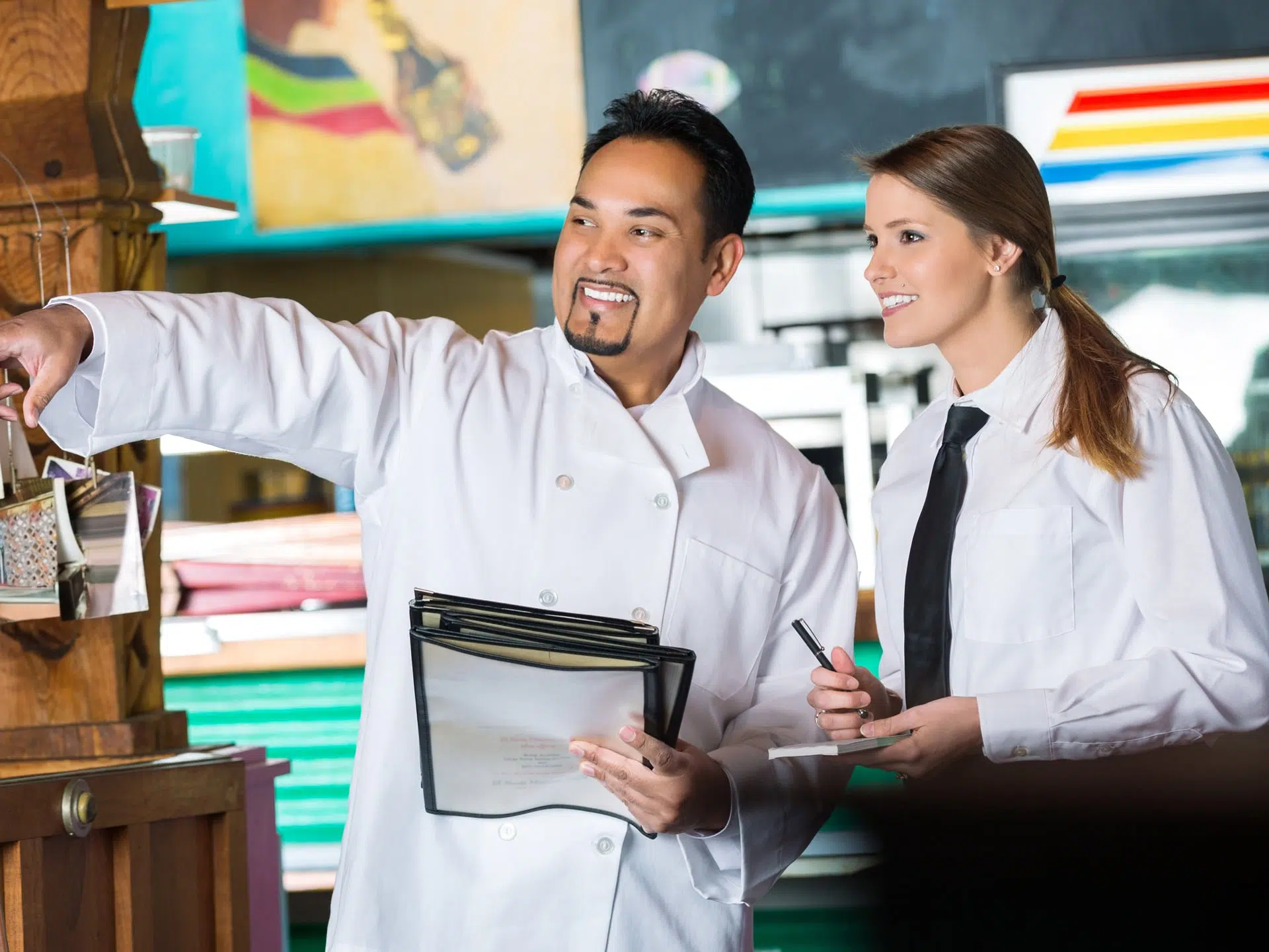 restaurant manager helping server