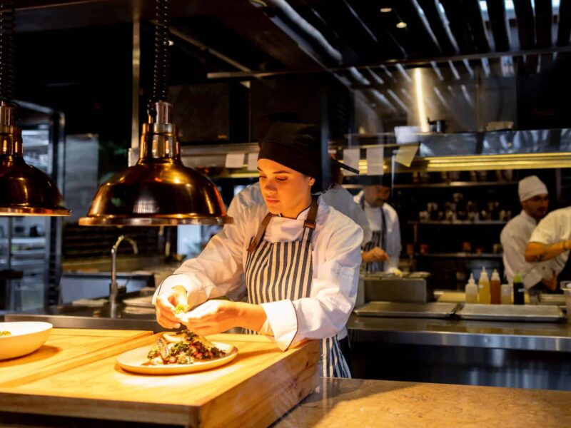 Female chef preparing a dish in a restaurant