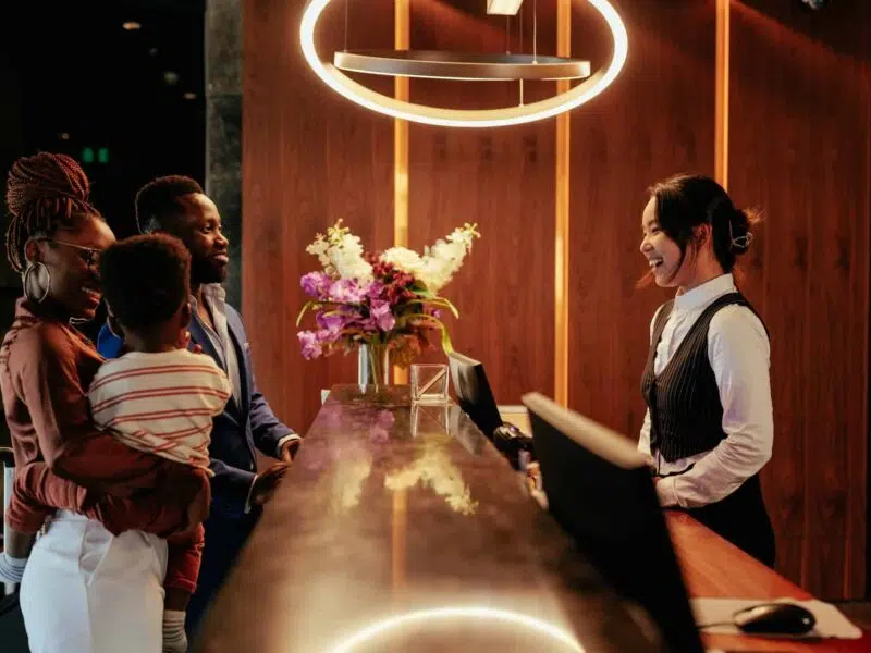 concierge checking in a family to a hotel
