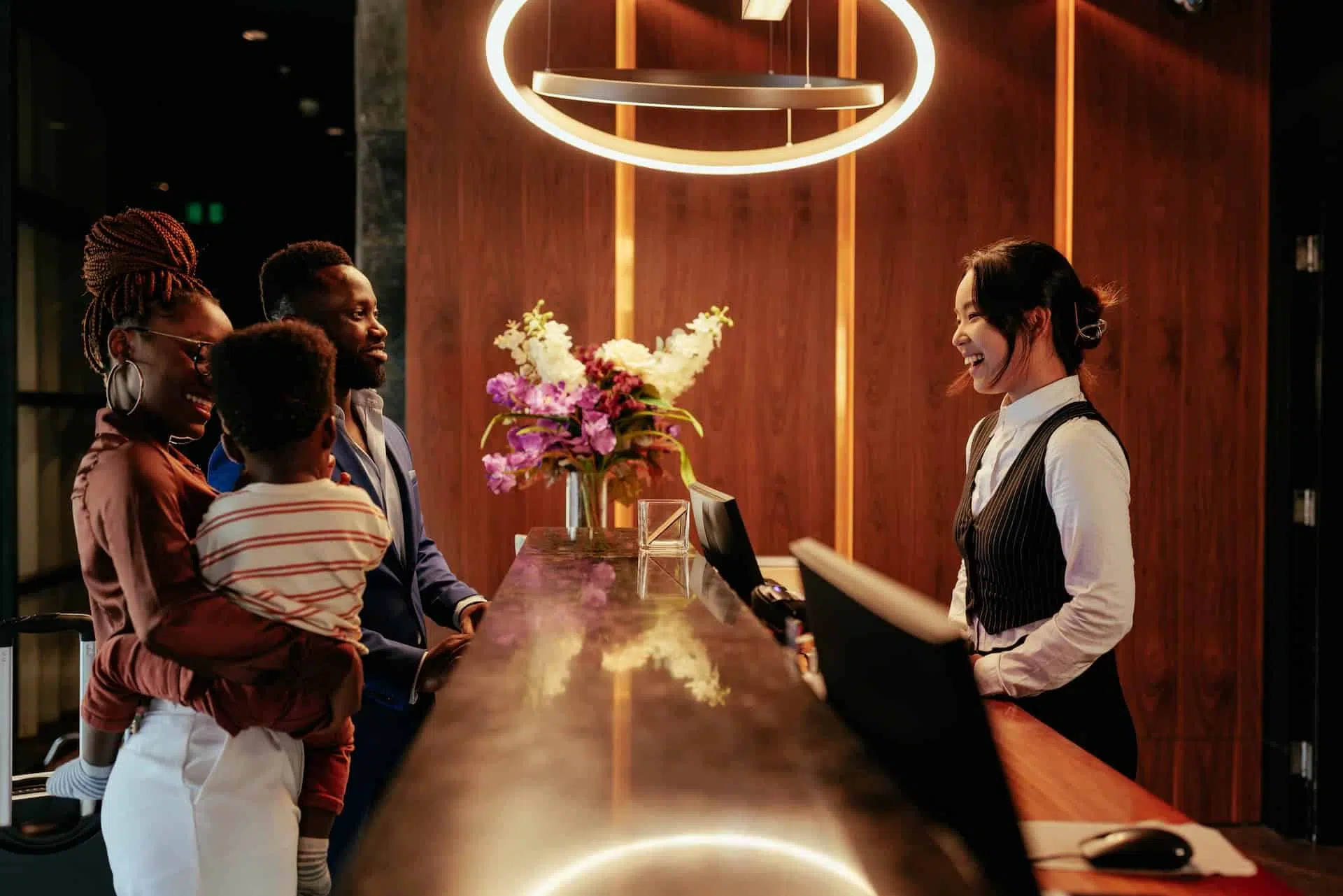 concierge checking in a family to a hotel