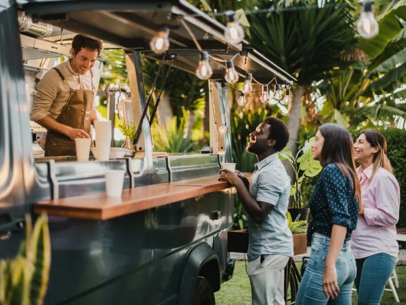 Happy people queueing at coffee van
