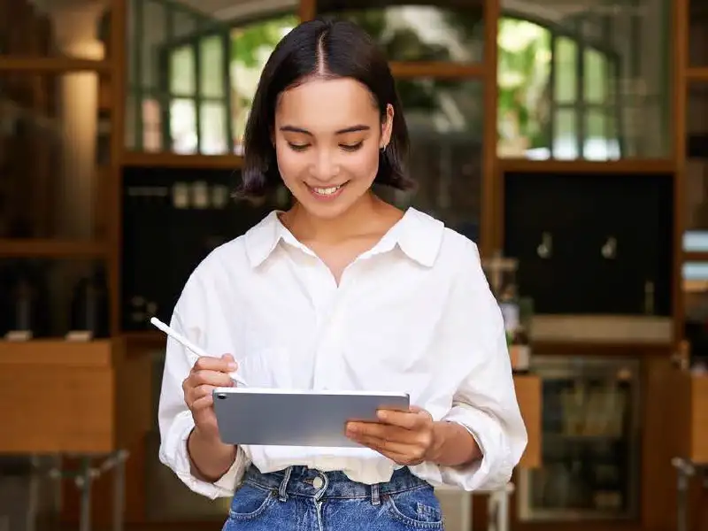 restaurant manager looking at tablet