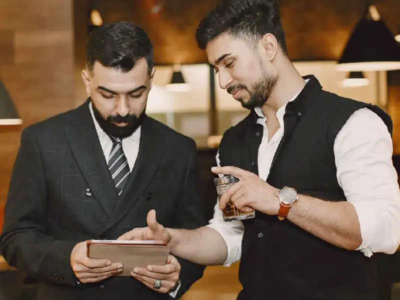 restaurant manager and bartender looking at tablet