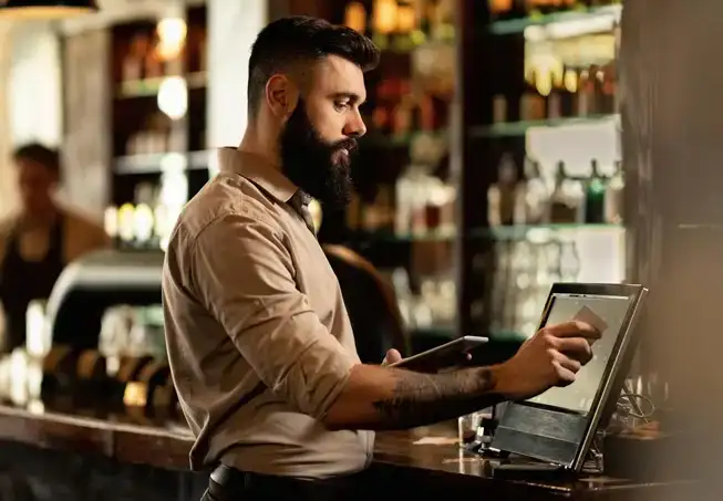 bartender closing out a check